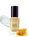 picture of i'm from honey serum with honey next to it and spread behind on a white background