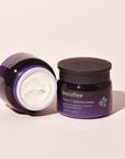 2 60 ml bottle of innisfree perfect 9 intensive cream next to each other with brown background, one open