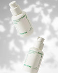 2 bottles of innisfree green tea seed hyaluronic serum suspended with wall background with leaf shades