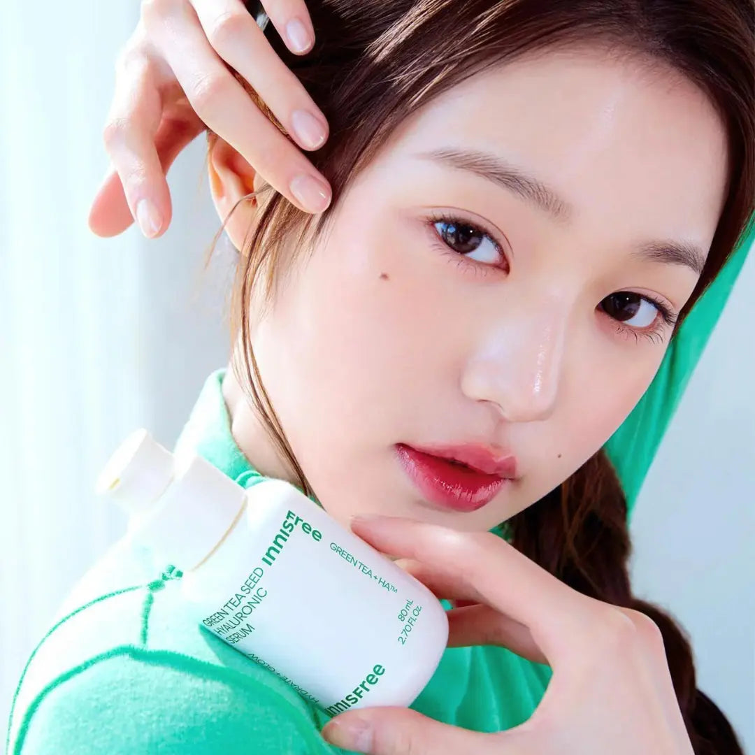 Asian woman pretty face using innisfree green tea seed hyaluronic serum